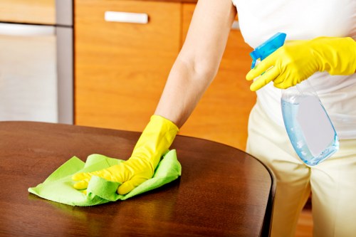 Local technician cleaning a sectional sofa in a Richmond property